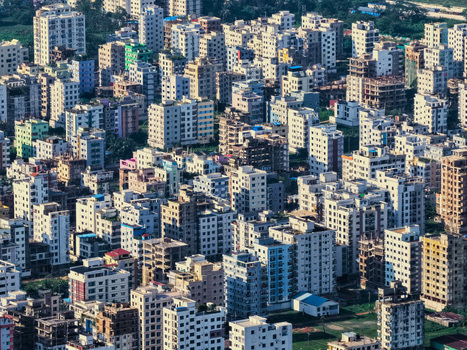 Aerial view of the dense urban landscape with numerous residential apartment buildings and rooftops in Chattogram Chittagong Division Bangladesh.