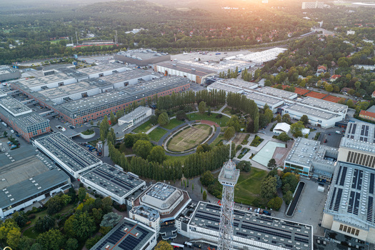 Aerial view of Messe Berlin exhibition grounds featuring the iconic Radio Tower and the lush Sommergarten surrounded by modern exhibition halls in Berlin Berlin Germany. Aerial view of Messe Berlin exhibition grounds featuring the iconic Radio Tower and the lush Sommergarten surrounded by modern exhibition halls in Berlin Berlin Germany.
