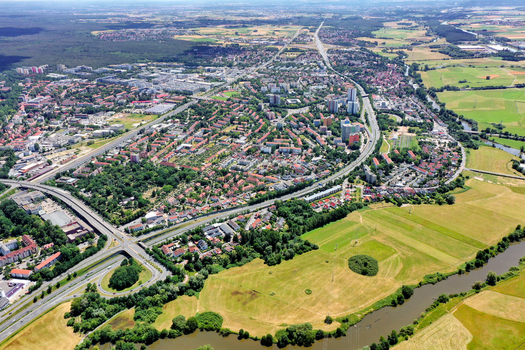 Aerial view of the A73 highway winding through residential districts and lush green fields along the Pegnitz river Nurnberg Bayern Germany. Aerial view of the A73 highway winding through residential districts and lush green fields along the Pegnitz river Nurnberg Bayern Germany.
