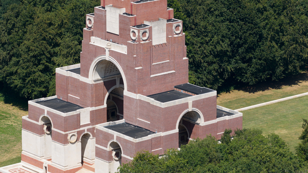 Aerial view of Thiepval Memorial to the Missing of the Somme a massive brick monument surrounded by lush green trees and manicured lawns in Thiepval Hauts de France France.