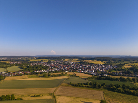 Aerial view of the town of Weingarten in the Kraichgau region surrounded by agricultural fields and lush green forests in Weingarten Baden Wurttemberg Germany. Aerial view of the town of Weingarten in the Kraichgau region surrounded by agricultural fields and lush green forests in Weingarten Baden Wurttemberg Germany.