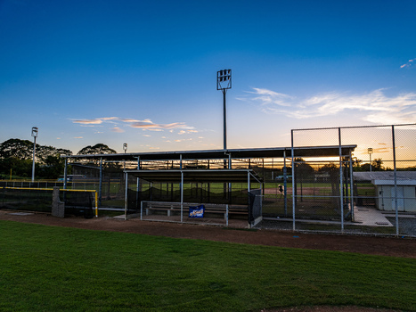 Aerial view of Quality Baseball Academy featuring a baseball field dugout and stadium lights under a sunset sky in San Antonio de Guerra Santo Domingo Provinc Dominican Republic. Aerial view of Quality Baseball Academy featuring a baseball field dugout and stadium lights under a sunset sky in San Antonio de Guerra Santo Domingo Provinc Dominican Republic.