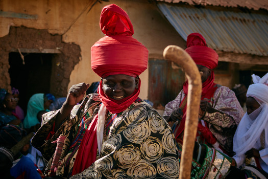 Zaria Nigerian 21 March 2026 View of prominent figures adorned in vibrant red turbans and richly patterned robes their smiles radiating against the rustic backdrop of an aged building. Zaria Nigerian 21 March 2026 View of prominent figures adorned in vibrant red turbans and richly patterned robes their smiles radiating against the rustic backdrop of an aged building.