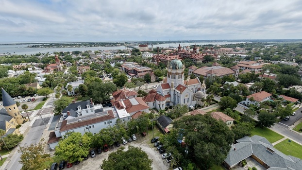 Aerial view of Memorial Presbyterian Church with its distinctive dome surrounded by historic buildings lush trees and urban streets in St. Augustine Florida United States.