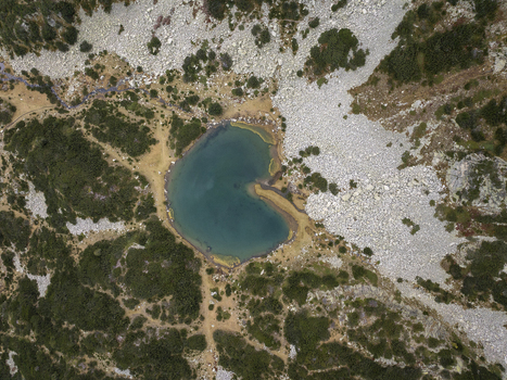 Aerial view of Muratovo Lake in Pirin National Park featuring its distinctive heart shaped basin surrounded by rocky alpine terrain and sparse vegetation in Blagoevgrad Province Bulgaria. Aerial view of Muratovo Lake in Pirin National Park featuring its distinctive heart shaped basin surrounded by rocky alpine terrain and sparse vegetation in Blagoevgrad Province Bulgaria.
