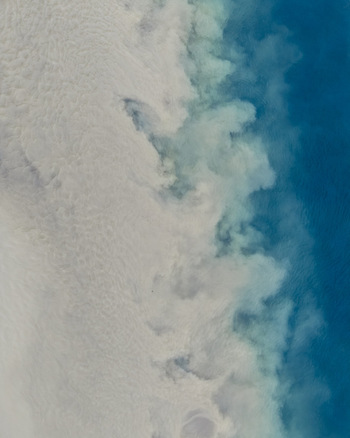 Aerial view of the coastline showing white surf and deep blue ocean waters near Selfoss Sveitarfelagid Arborg Iceland. Aerial view of the coastline showing white surf and deep blue ocean waters near Selfoss Sveitarfelagid Arborg Iceland.