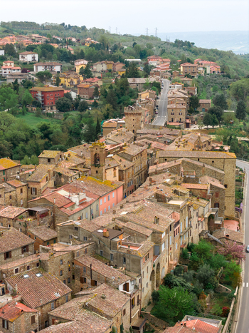 Aerial view of the historic stone buildings and terracotta rooftops of the medieval village nestled among the rolling green hills of the countryside in Ficulle Umbria Italy. Aerial view of the historic stone buildings and terracotta rooftops of the medieval village nestled among the rolling green hills of the countryside in Ficulle Umbria Italy.