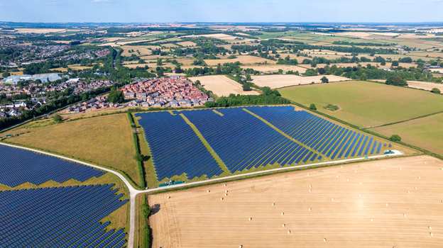 Aerial view of a large solar farm with rows of photovoltaic panels situated in the rural landscape of Dorset England United Kingdom. Aerial view of a large solar farm with rows of photovoltaic panels situated in the rural landscape of Dorset England United Kingdom.