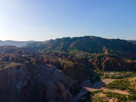 Aerial view of the rugged landscape surrounding the Khewra Salt Mine with rocky mountain ridges sparse vegetation and winding paths in Khewra Punjab Pakistan.