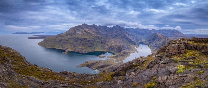 View of Sgurr na Stri overlooking the rugged Cuillin mountains Loch Coruisk and the dramatic coastline under a cloudy sky in Isle of Skye Scotland United Kingdom. View of Sgurr na Stri overlooking the rugged Cuillin mountains Loch Coruisk and the dramatic coastline under a cloudy sky in Isle of Skye Scotland United Kingdom.
