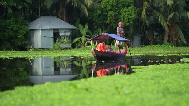 View of a traditional boat on a canal in Barishal Bangladesh. View of a traditional boat on a canal in Barishal Bangladesh.
