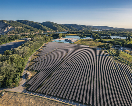 Aerial view of solar photovoltaic panels forming geometric rows at a utility scale solar farm in Le Pouzin Auvergne Rhone Alpes France. Aerial view of solar photovoltaic panels forming geometric rows at a utility scale solar farm in Le Pouzin Auvergne Rhone Alpes France.