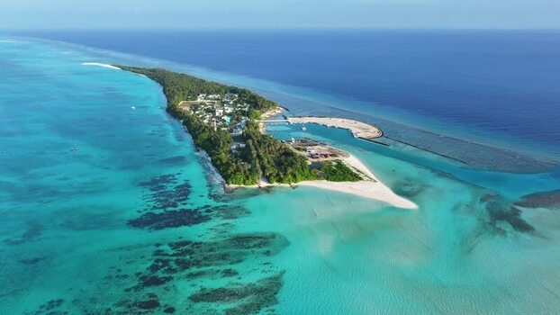 Aerial view of Fulhadhoo island with turquoise lagoon and harbor Maldives. Aerial view of Fulhadhoo island with turquoise lagoon and harbor Maldives.