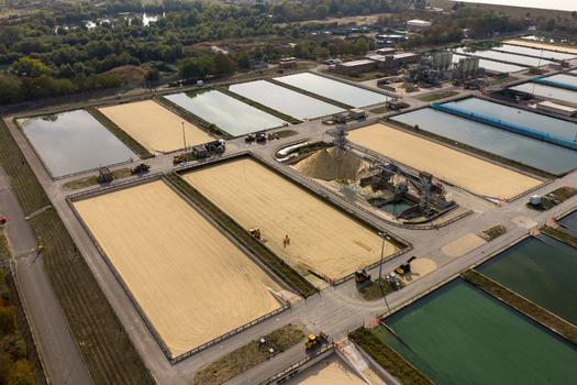 Aerial view of Ashford Common Water Treatment Works featuring large rectangular filtration beds sand filled basins and industrial machinery in Shepperton England United Kingdom. Aerial view of Ashford Common Water Treatment Works featuring large rectangular filtration beds sand filled basins and industrial machinery in Shepperton England United Kingdom.