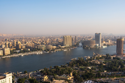 Cairo Egypt 19 October 2025 View of the Nile River winding through the urban landscape with the Cairo Tower standing tall against the hazy horizon. Cairo Egypt 19 October 2025 View of the Nile River winding through the urban landscape with the Cairo Tower standing tall against the hazy horizon.