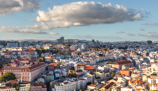 Aerial view of the historic cityscape of Lisbon featuring dense terracotta rooftops traditional architecture and urban streets in Lisbon Lisbon Portugal.
