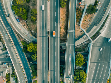 Aerial view of the Cikunir highway interchange featuring multi level roads moving vehicles and surrounding greenery in Kecamatan Bekasi Selatan Jawa Barat Indonesia. Aerial view of the Cikunir highway interchange featuring multi level roads moving vehicles and surrounding greenery in Kecamatan Bekasi Selatan Jawa Barat Indonesia.