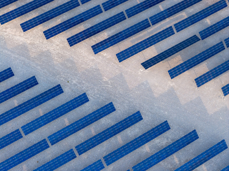 Aerial view of rows of blue solar panels arranged in geometric patterns on dry desert ground Enterprise Nevada United States. Aerial view of rows of blue solar panels arranged in geometric patterns on dry desert ground Enterprise Nevada United States.