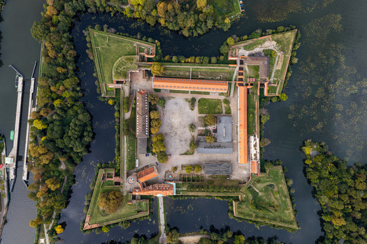 Aerial view of Spandau Citadel a historic star shaped fortress surrounded by water and lush trees in Berlin Berlin Germany.