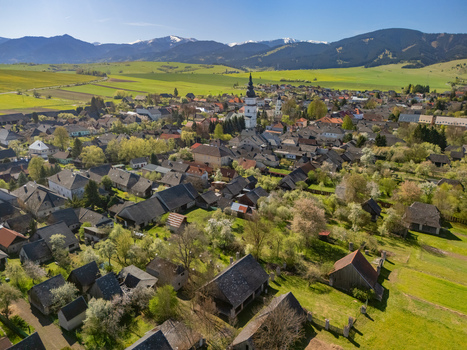 Aerial view of the historic village with its church tower traditional houses and mountains in the background Partizanska Lupca Zilina Region Slovakia.