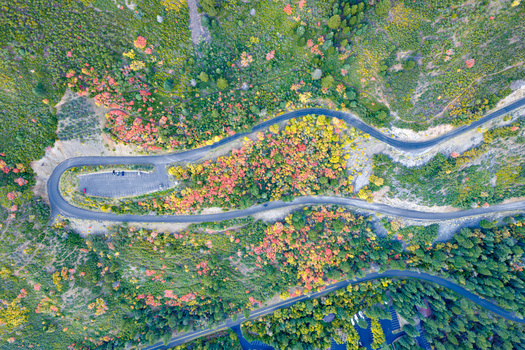 Aerial view of the winding Alpine Loop Scenic Byway surrounded by vibrant autumn foliage colorful trees and mountain terrain in Utah County Utah United States. Aerial view of the winding Alpine Loop Scenic Byway surrounded by vibrant autumn foliage colorful trees and mountain terrain in Utah County Utah United States.