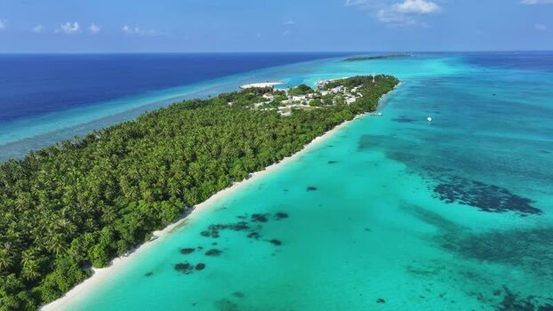 Aerial view of Fulhadhoo island with palm trees and coral reefs Maldives Aerial view of Fulhadhoo island with palm trees and coral reefs Maldives
