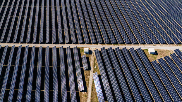 Aerial view of a large solar farm with rows of photovoltaic panels arranged in parallel lines across the landscape in Temerin Vojvodina Serbia. Aerial view of a large solar farm with rows of photovoltaic panels arranged in parallel lines across the landscape in Temerin Vojvodina Serbia.