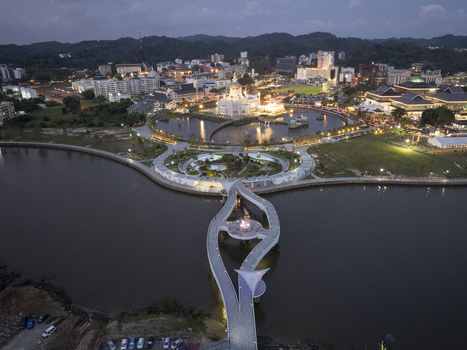 Aerial view of the illuminated Omar Ali Saifuddien Mosque and the modern pedestrian bridge at Taman Mahkota Jubli Emas during twilight Bandar Seri Begawan Brunei Muara District Brunei. Aerial view of the illuminated Omar Ali Saifuddien Mosque and the modern pedestrian bridge at Taman Mahkota Jubli Emas during twilight Bandar Seri Begawan Brunei Muara District Brunei.