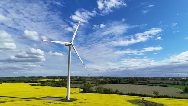 Aerial view of a wind turbine in a yellow rapeseed field Germany. Aerial view of a wind turbine in a yellow rapeseed field Germany.