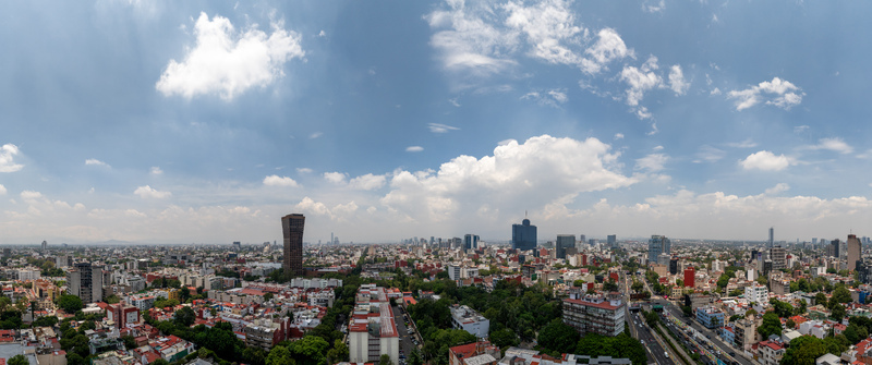 Mexico City Mexico 25 September 2026 Aerial view of the urban landscape of Mexico City with its dense mix of skyscrapers residential buildings lush trees and a cloudy sky. Mexico City Mexico 25 September 2026 Aerial view of the urban landscape of Mexico City with its dense mix of skyscrapers residential buildings lush trees and a cloudy sky.
