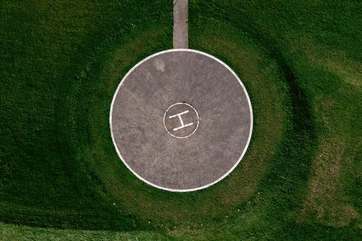 Aerial view of a circular helipad with a white H marking surrounded by lush green grass in Vilnius Vilnius County Lithuania.