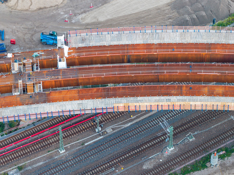Aerial view of the Ringbahnbrucke bridge construction site featuring curved rusted steel girders and railway tracks at the Funkturm interchange in Berlin Berlin Germany. Aerial view of the Ringbahnbrucke bridge construction site featuring curved rusted steel girders and railway tracks at the Funkturm interchange in Berlin Berlin Germany.