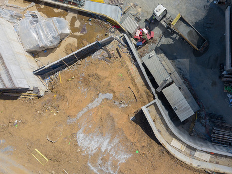 Aerial view of a construction site featuring exposed earth concrete foundations construction materials and a dump truck parked on a paved area in Istanbul Istanbul Turkiye. Aerial view of a construction site featuring exposed earth concrete foundations construction materials and a dump truck parked on a paved area in Istanbul Istanbul Turkiye.
