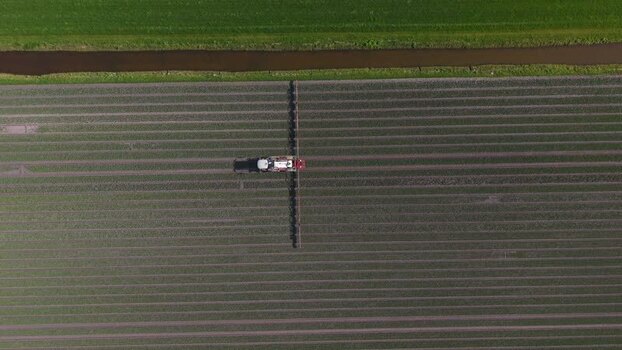 Aerial view of tractor in field Opmeer North Holland Netherlands. Aerial view of tractor in field Opmeer North Holland Netherlands.