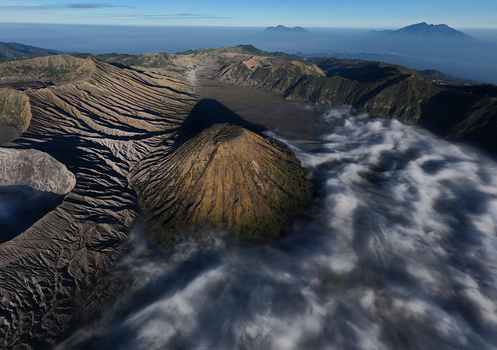 Aerial view of Mount Bromo with its volcanic crater rugged landscape and surrounding sea of clouds in Kecamatan Sukapura Jawa Timur Indonesia.