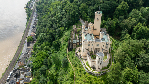 Aerial view of Stolzenfels Castle nestled on a lush green hillside overlooking the Rhine river and surrounding forest in Koblenz Rheinland Pfalz Germany. Aerial view of Stolzenfels Castle nestled on a lush green hillside overlooking the Rhine river and surrounding forest in Koblenz Rheinland Pfalz Germany.