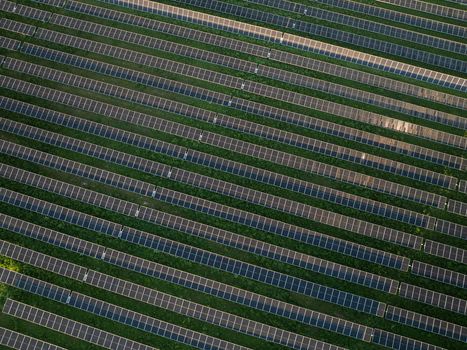 Aerial view of a large solar panel farm with rows of photovoltaic panels on green grass in Augusta Sicily Italy. Aerial view of a large solar panel farm with rows of photovoltaic panels on green grass in Augusta Sicily Italy.