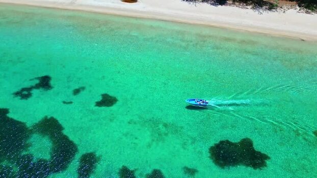 Aerial view of a boat in turquoise waters of Guanaja Honduras. Aerial view of a boat in turquoise waters of Guanaja Honduras.