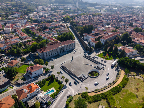 Aerial view of the Judicial Court of Guimaraes situated in a historic urban square surrounded by traditional rooftops and greenery in Guimaraes Braga Portugal. Aerial view of the Judicial Court of Guimaraes situated in a historic urban square surrounded by traditional rooftops and greenery in Guimaraes Braga Portugal.