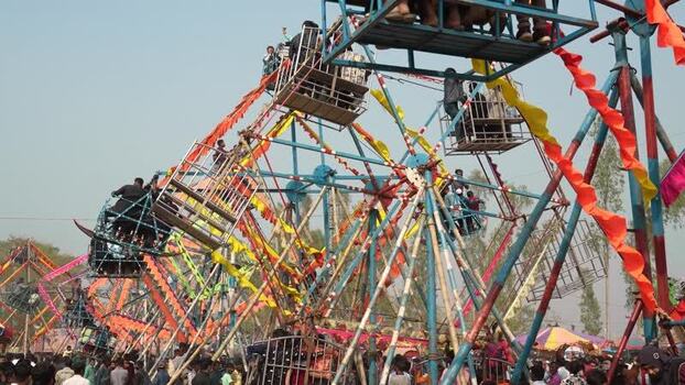View of traditional Ferris wheels at a fair in Bangladesh. View of traditional Ferris wheels at a fair in Bangladesh.