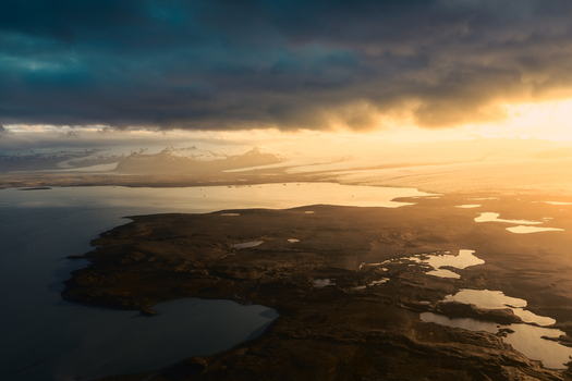 Aerial view of Jokulsarlon glacier lagoon at golden hour with dramatic clouds and glacial landscape in Sveitarfelagid Hornafjordur Iceland. Aerial view of Jokulsarlon glacier lagoon at golden hour with dramatic clouds and glacial landscape in Sveitarfelagid Hornafjordur Iceland.