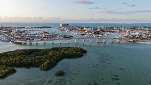 Aerial view of the Yucalpeten bridge spanning the waterway near the marina and lush mangroves under a clear sky in Progreso Yucatan Mexico. Aerial view of the Yucalpeten bridge spanning the waterway near the marina and lush mangroves under a clear sky in Progreso Yucatan Mexico.