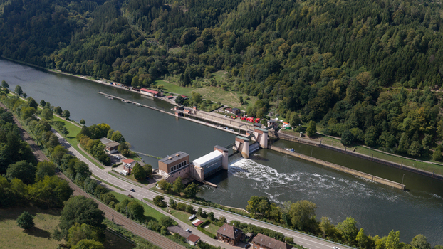 Aerial view of the Rockenau Lock and Weir on the Neckar River surrounded by dense forests and lush greenery in Eberbach Baden Wurttemberg Germany. Aerial view of the Rockenau Lock and Weir on the Neckar River surrounded by dense forests and lush greenery in Eberbach Baden Wurttemberg Germany.