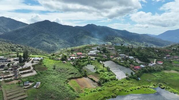 Aerial view of Alahan Panjang village and green hills Indonesia. Aerial view of Alahan Panjang village and green hills Indonesia.