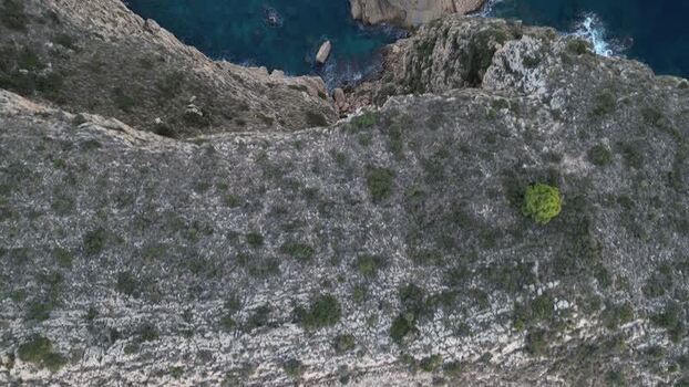 Aerial view of rugged cliffs and rocky coastline in Spain.