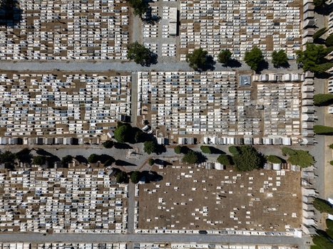 Aerial view of the historic cemetery with organized rows of white graves stone pathways and scattered trees in Evora Evora District Portugal. Aerial view of the historic cemetery with organized rows of white graves stone pathways and scattered trees in Evora Evora District Portugal.