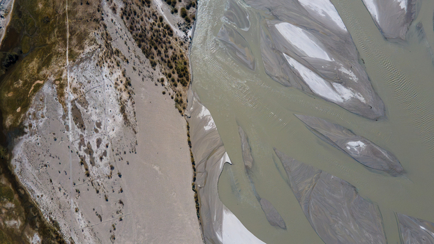 Aerial view of the Shigar River featuring intricate braided channels sandy riverbanks and arid terrain in Skardu Gilgit Pakistan.