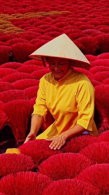 View of a person working with red bundles Vietnam.