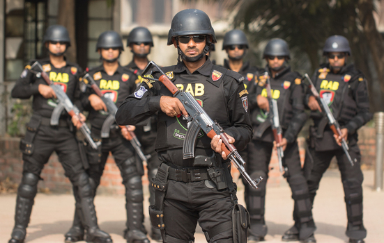 Dhaka Bangladesh 06 January 2017 View of Rapid Action Battalion RAB officers in black tactical gear holding rifles during a formation at the RAB Headquarters. Dhaka Bangladesh 06 January 2017 View of Rapid Action Battalion RAB officers in black tactical gear holding rifles during a formation at the RAB Headquarters.