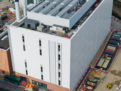 Aerial view of a modern data center building with industrial rooftop equipment and construction site elements in the United Kingdom. Aerial view of a modern data center building with industrial rooftop equipment and construction site elements in the United Kingdom.